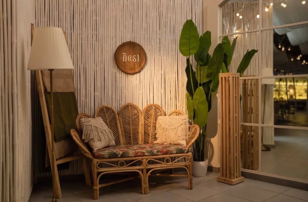 Boho-style seating area with rattan sofa and plants.